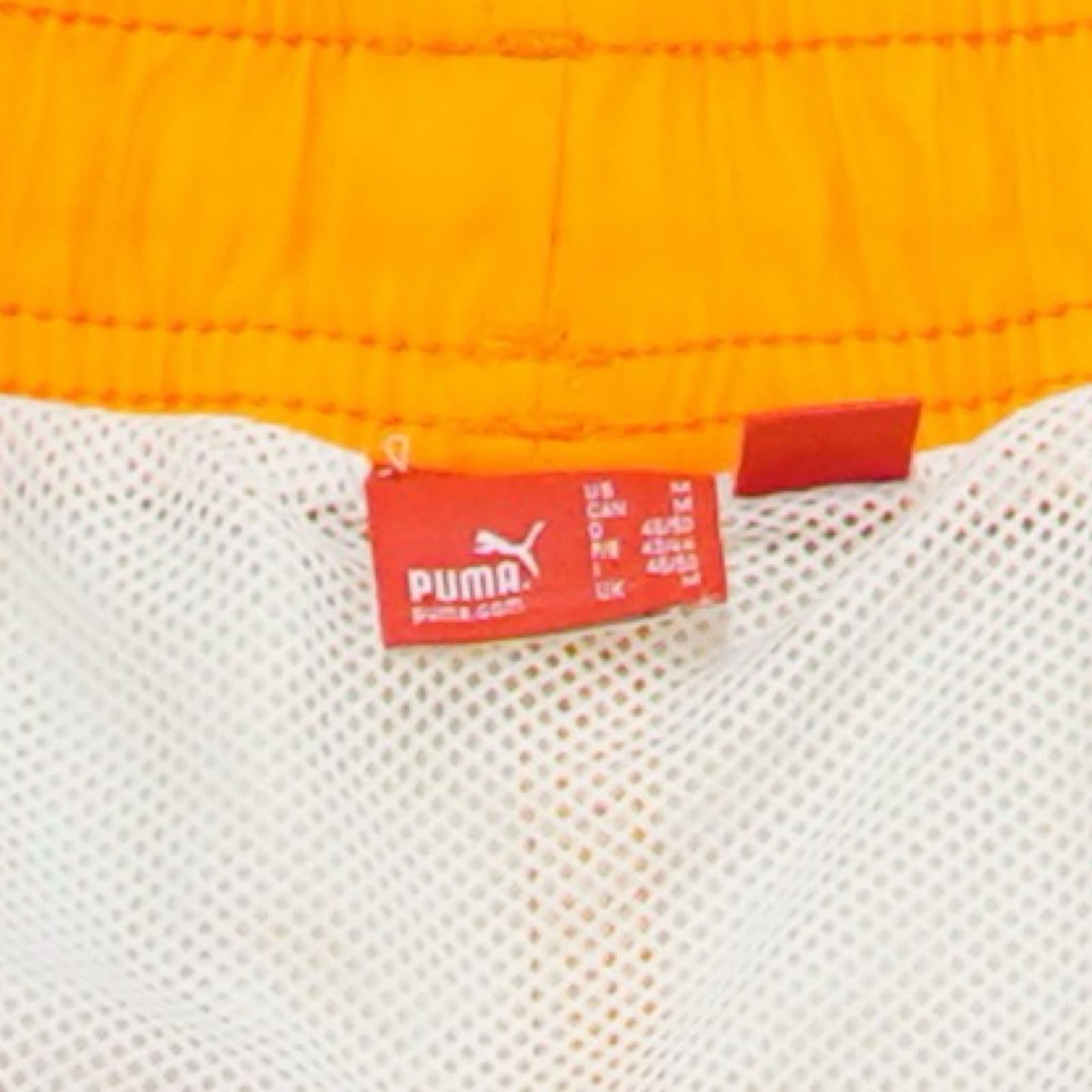 Pánské oranžové plavky značky Puma.. Puma Orange Flowers Shorts